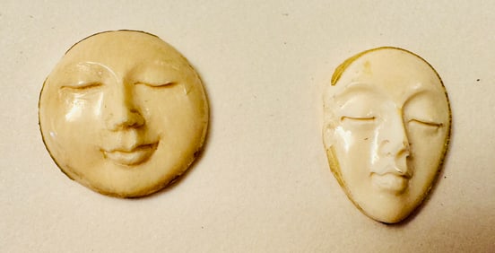 Bone carved faces - two