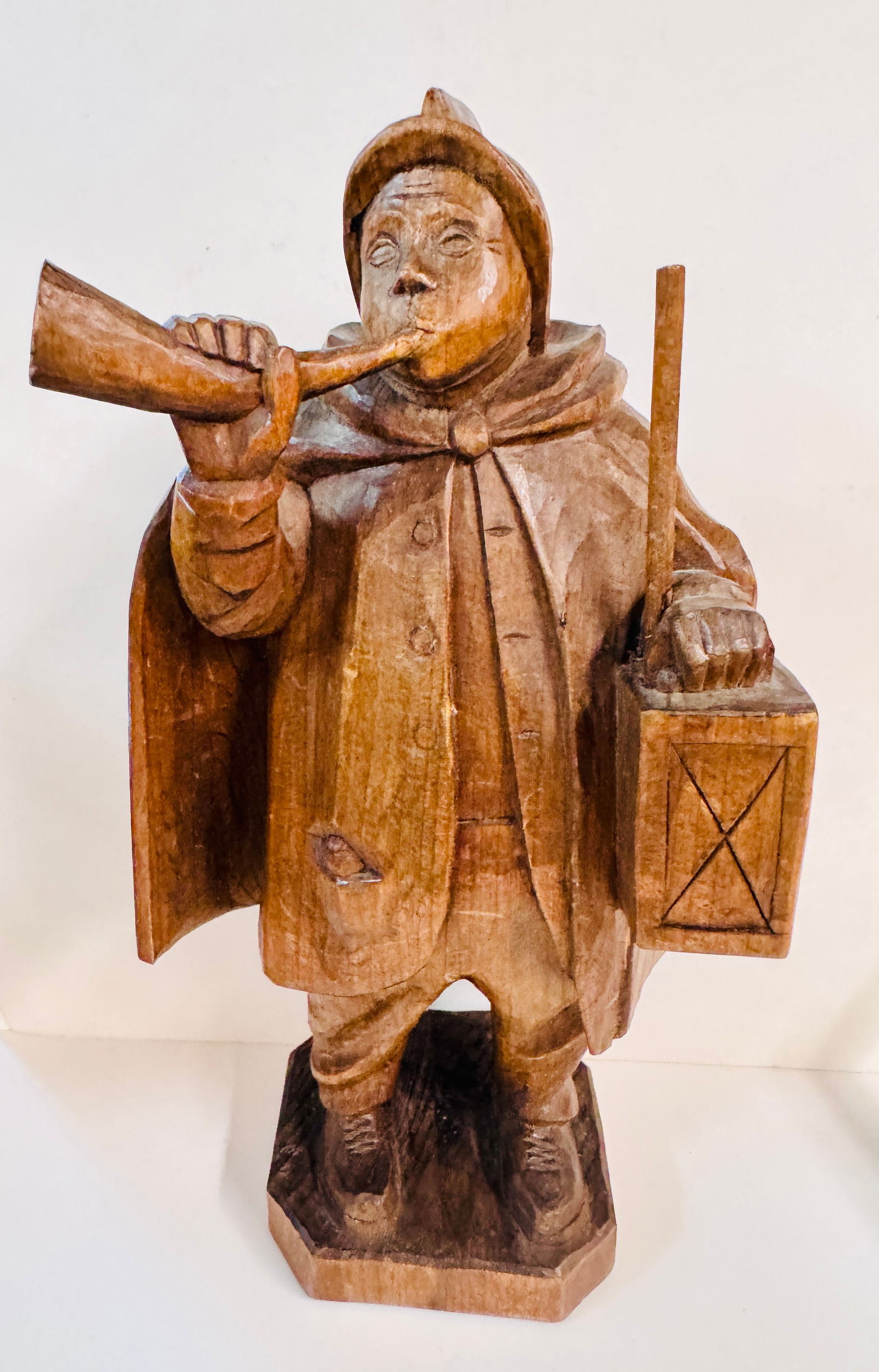 Carved German figural statue wood: Possible Black Forest carving of gentleman vintage blowing horn with lantern in other hand . Has unique hat and coat from early times. Carving is all from one block of wood and is nicely detailed. Abo