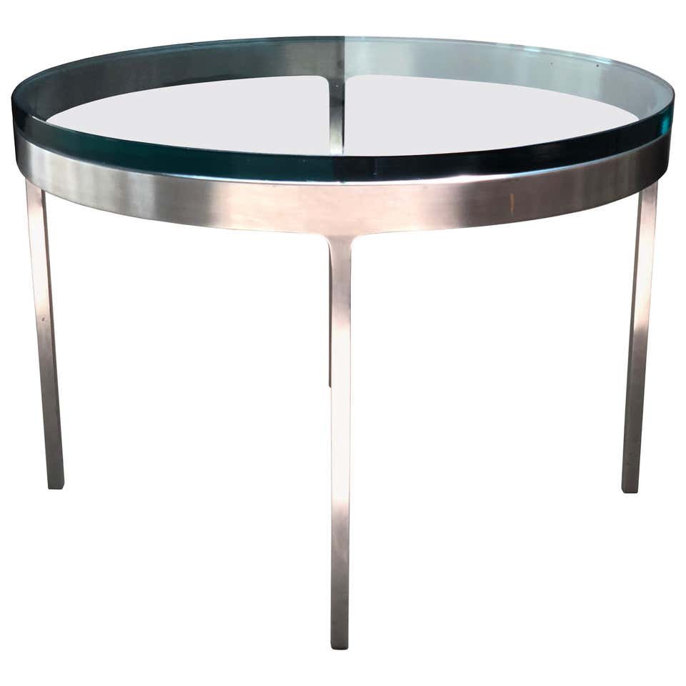 Nicos Zographos Table in Polished Stainless & Glass: Vintage side table designed by Nicos Zographos and manufactured in the 1970s.The table comes with a thick clear glass top and can also be amazing with marble.The table is in good vintage condition and