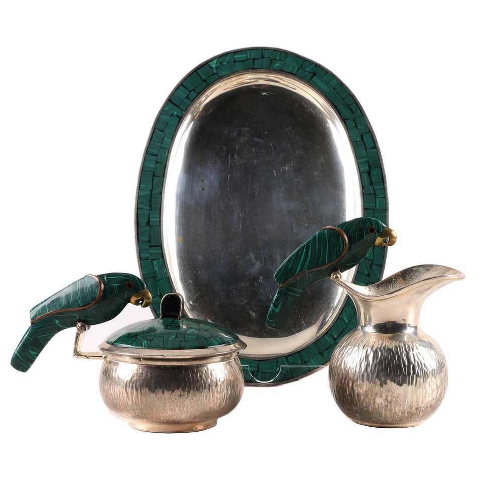 Silver Plate & Malachite Tea Set by Los Fajardo: Vintage serving set in silver, malachite and brassby Los Fajardo of Taxco.The creamer and sugar caddie are beautifully adorned with a parrot perching on the rim of the bowl and pitcher, the parrot is