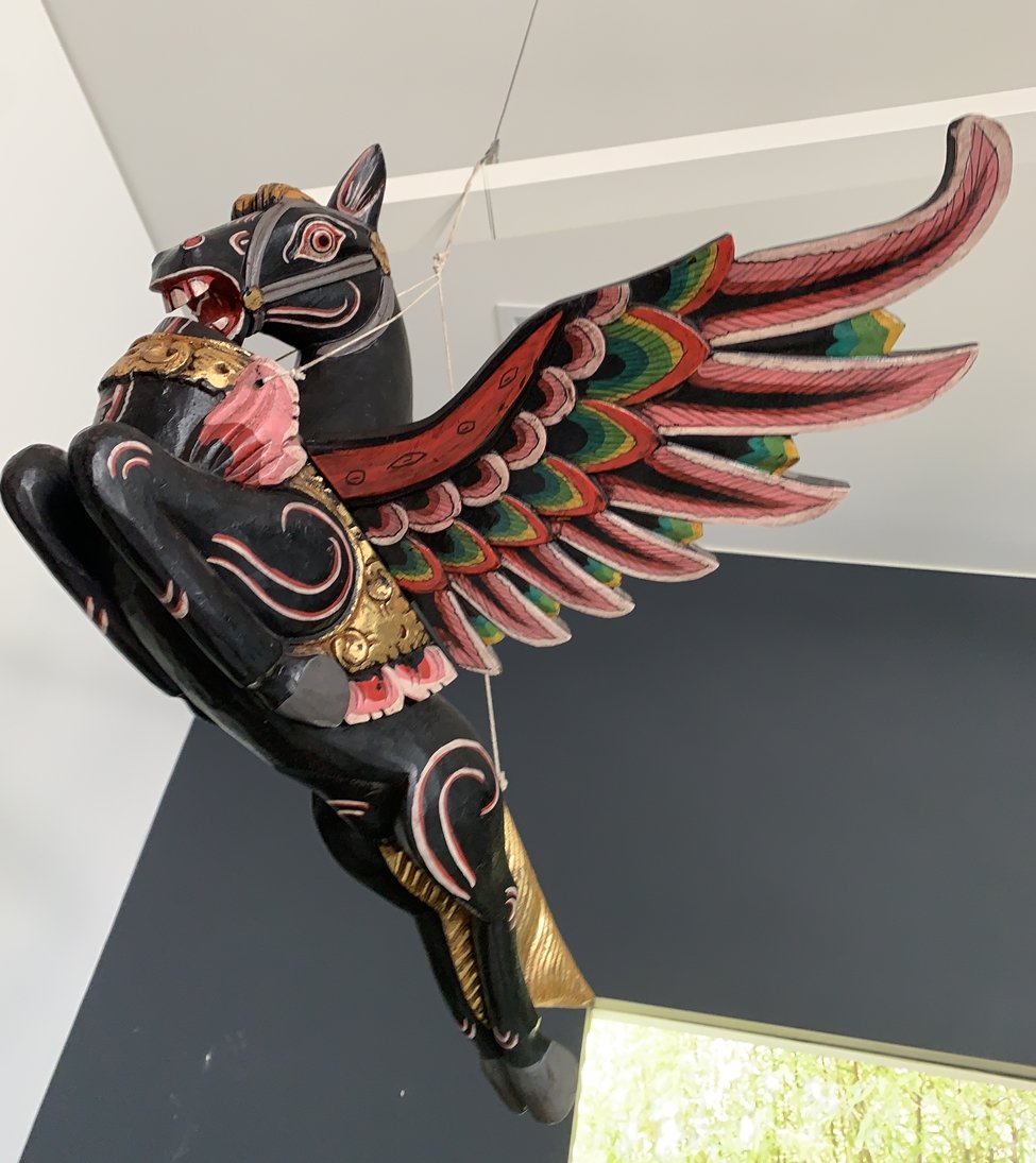 Flying Horse Wood Sculpture: Beautful flying horse sculpture that is meant to be suspended when displayed, hand painted in xolorful tones.Good condition.Measurements:26.50 inches wide x 23.50 wing span/depth x 11.50 inches high x