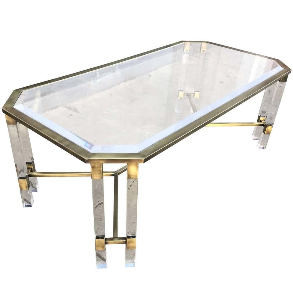 Vintage Italian Lucite and Brass Coffee Table: Stunning brass and Lucite coffee table made in Italy in the late 1960s early 1970s. The coffee table comes with a beautiful Lucite top with bevel edges and a double Lucite legs on each corner and a br