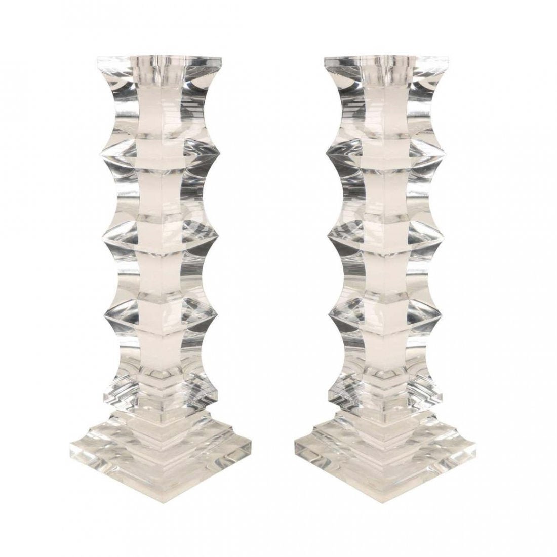 Sculptural Pair of Lucite Candleholders: Sculptural set of vintage candleholders executed in Lucite and finely hand-carved to be very prismatic and reflect light just like a diamond. The candle holders are very well proportioned and they are