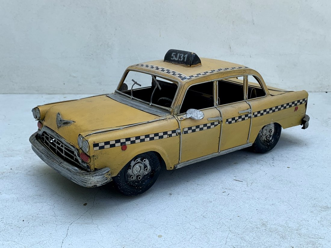Metal Yellow Cab Sculpture: Beautiful cam sculpture, great attention to detail, equipped with rear and front seats, the doors do not open and the wheels do not turn. Great condition. Unsigned. Measurements: 13 inches wide x 6 in