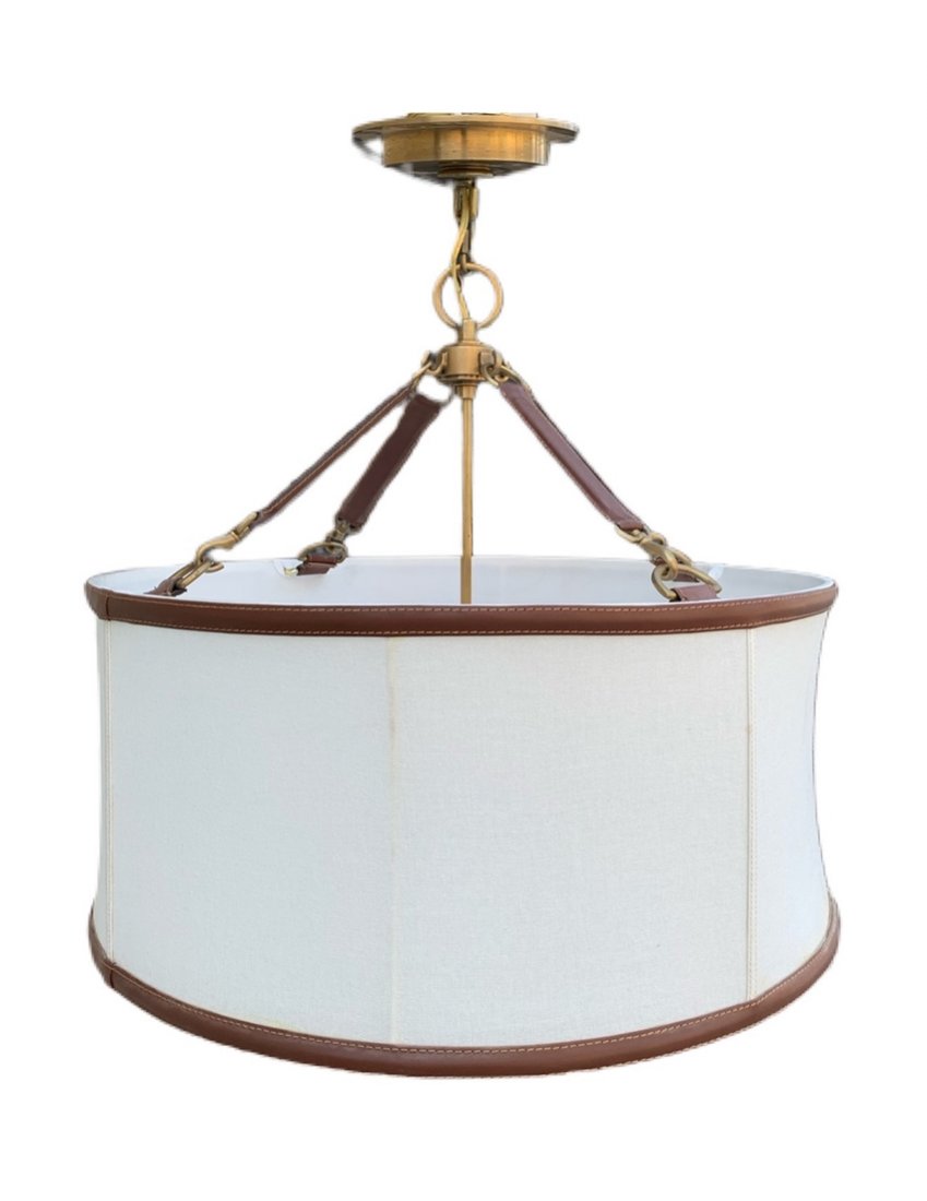 Ralph Lauren Leather & Brass Drum Chandelier: This equestrian-inspired hanging shade is crafted of linen with leather accents and brass detailing. Hardwired.Measurements:26 inches high x 24 inches in diameter Shade is 11 inches high.All items are