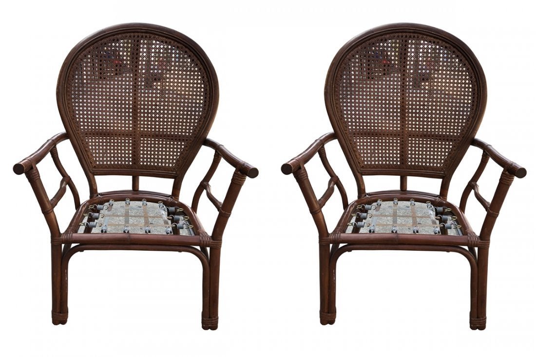 Pair of Ballon-Back Armchairs by Ficks Reed: Chic midcentury pair of armchairs made by Ficks Reed in the Hollywood Regency taste. Features an iconic balloon shaped back with an open fretwork pattern design. The rattan frame is reinforced with ba