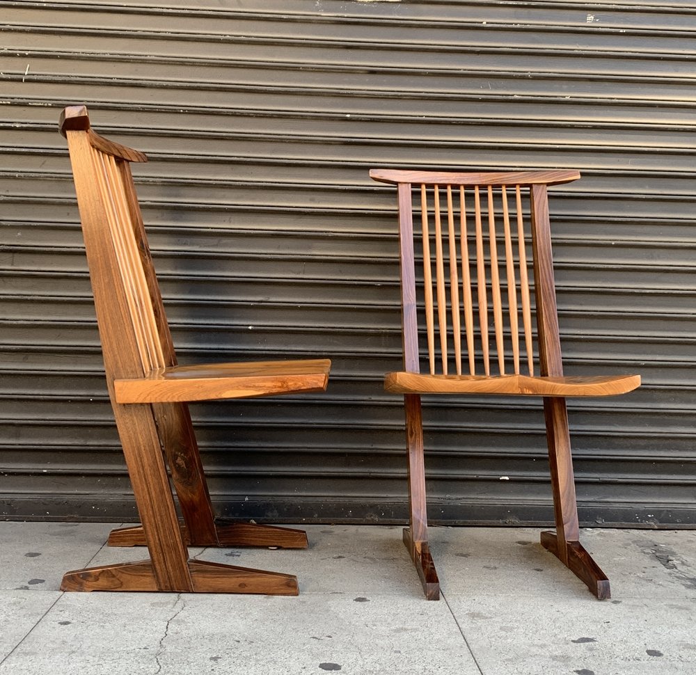 Pair of Nakashima Style Conoid Chairs: Walnut conoid chair in the manner of George Nakashima. The piece also features a comb shaped back and molded seat. Please note of wear consistent with age. Measurements: Height: 41.00 in. (104.14 cm) 