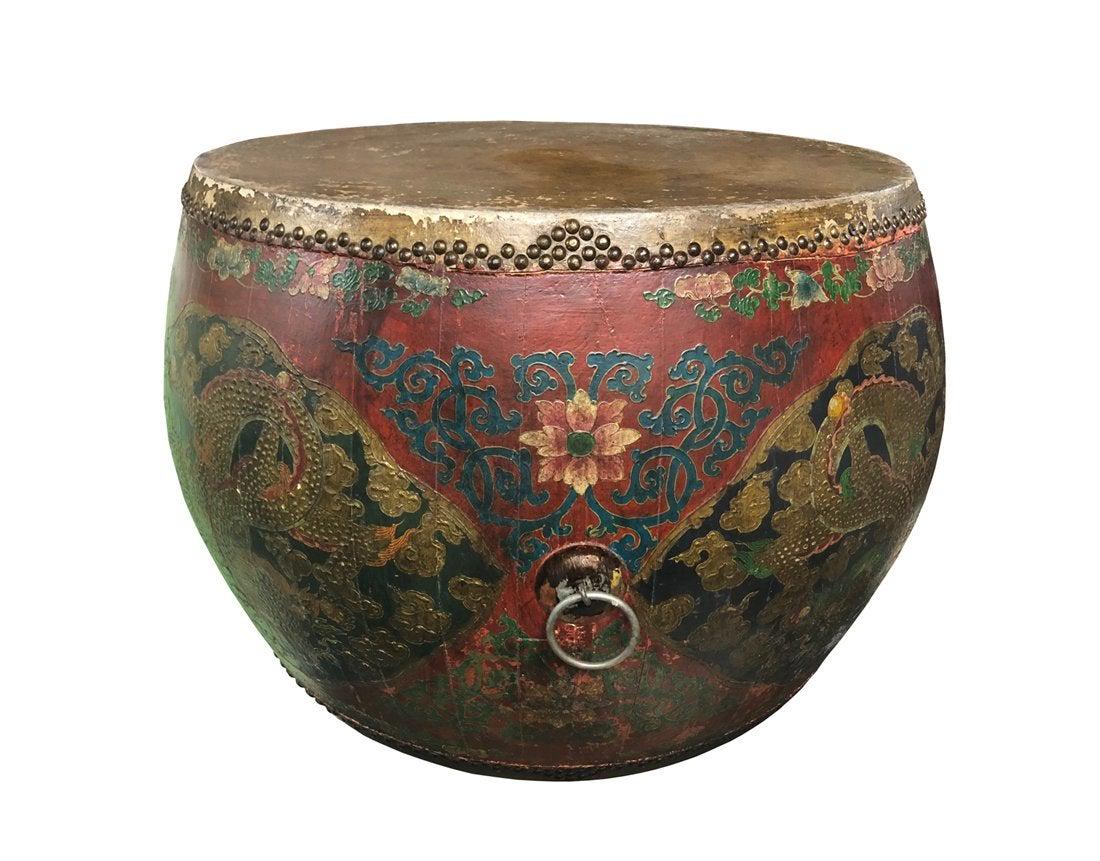 Chinese-style 19/20th Century drum-shaped coffee Table: Turn of the century Chinese coffee table carved in a round, drum form and decorated with traditional Asian red and green lacquer motifs and metal ring finishes. Measurements: 34 inches in diameter x 2