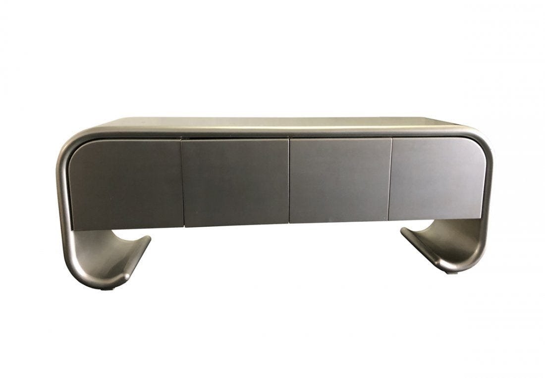 Karl Springer Style Sideboard with Scrolled Legs: Stunning sideboard in the style of Karl Springer, the piece has sculptural lines, a scrolled base and there are four doors.The piece has a silver finish and shows well but it does have nicks, scratche