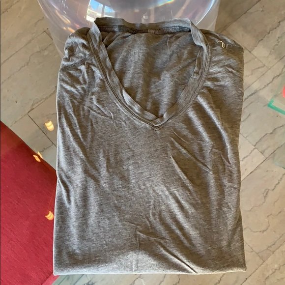 Lululemon men’s V neck Shirt size M, Gray color: Nice Lululemon men’s workout or active shirt, V neck, soft and well worn but in fair to good condition, 2 small holes and one larger hole on the back, a bit stretched out, it can fit a loose Medium 