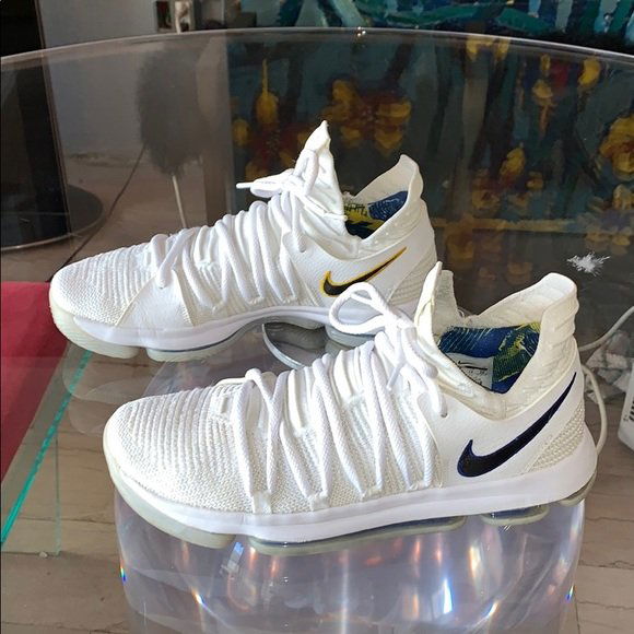 Kevin Durant's Opening Night Sneakers W/ NBA Logos: Presumably Kevin Durant's sneakers for the first game of the 2017-18 NBA season (also, Ring Night), the "Opening Night" Nike KD 10 features a clean, Warriors-inspired palette of white, royal and gold.