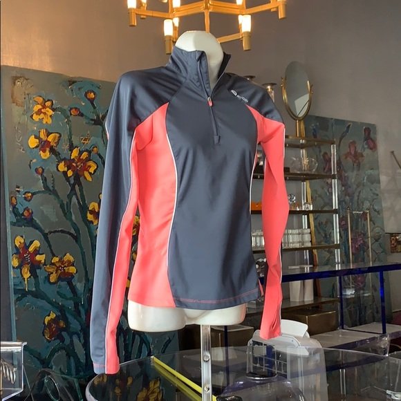 Cycling Jacket in size XS by SUGOi: Beautiful long sleeve jacket designed and manufactured by SUGOi, size XS, mock neck with zipper closure, a pocket on the left upper sleeve, gray reflective lines on the front and back, excellent condi