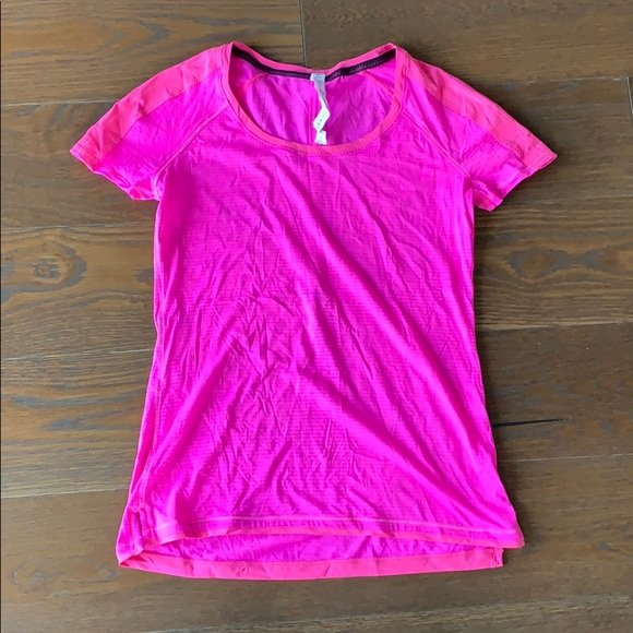 Short Sleeve Workout shirt by Lululemon size 4: Beautiful workout shirt designed and manufactured by Lululemon, size 4, hot pink color with grayish pin stripes, good condition with some very faded bluish marks on the front as per photos. 16” pit 