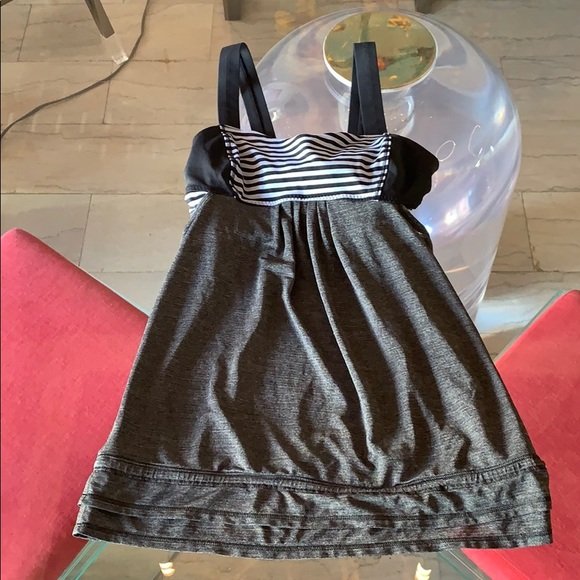 Lululemon workout top in size 4 exc condition: Beautiful workout top by Lululemon in size 4, little to no wear, lavender and black stripes on the bra area charcoal gray and black on the bottom and straps. 25” full length. ANY CONDITION STATEMENT