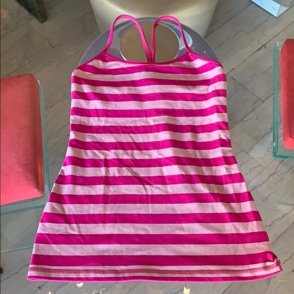 Lululemon Stripped Workout Top size 6: Nice workout top by Lululemon in size 6, pink stripes, used but in good condition. 25” length x 14” pit to pit x 14” waist x 17” at bottom. ANY CONDITION STATEMENT IS GIVEN AS A COURTESY TO A 