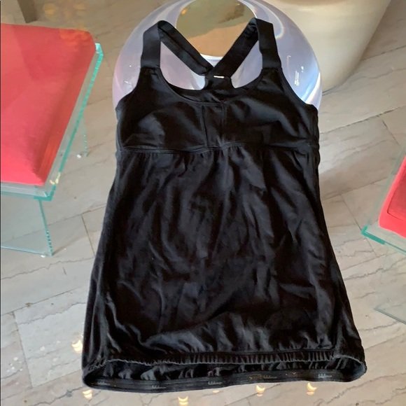 Lululemon Workout/Relaxing top size 6, with Bra: Beautiful black workout or athletic top by Lululemon, size 6, integrated bra, elastic band at the bottom, excellent condition. 13” pit to pit x 24” length From a pet and smoke free home. ANY CONDI