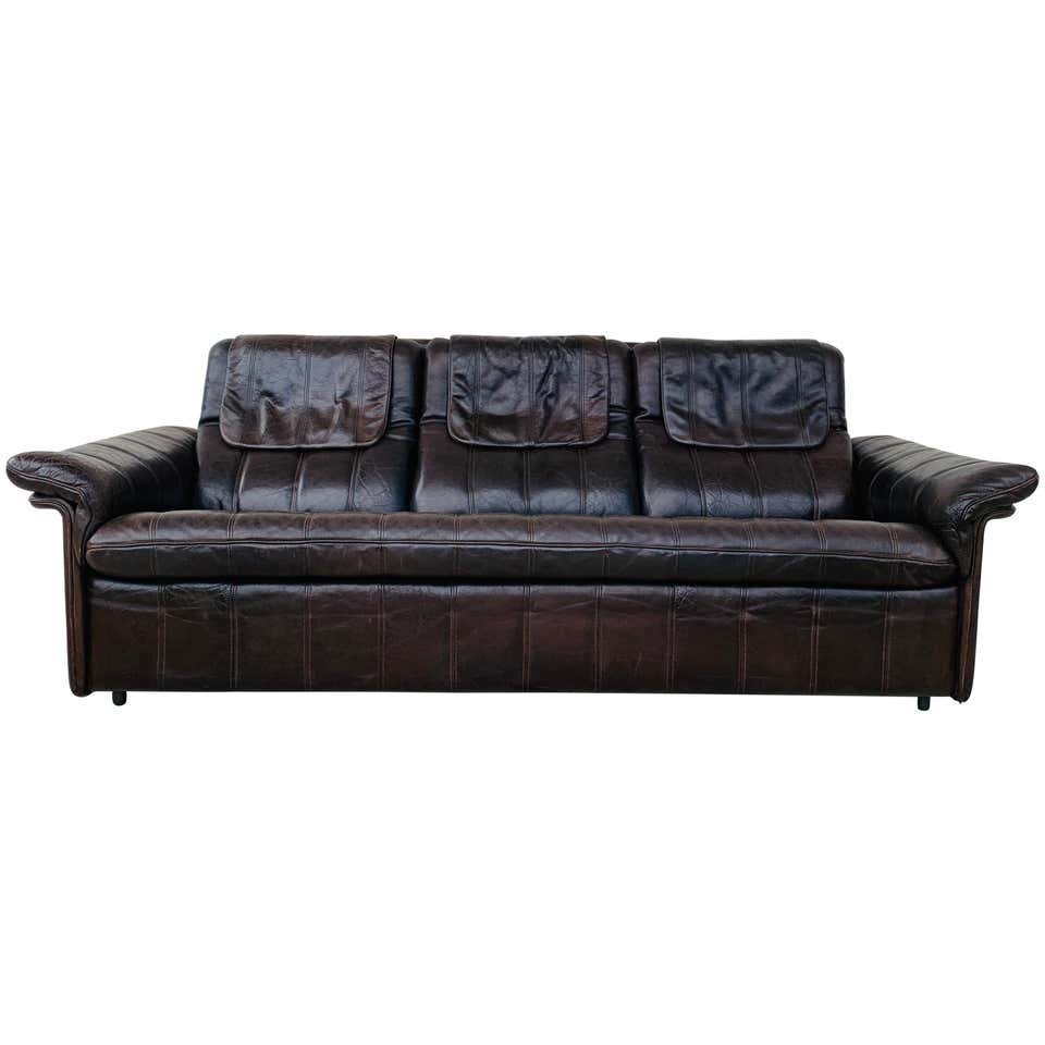 3-Seat Leather Sofa by De Sede, Switzerland: Vintage 3-seat sofa upholstered in brown leather designed and manufactured in Switzerland by De Sede.The piece is all original and is in good vintage condition.Measurements:79 inches wide x 33 inches