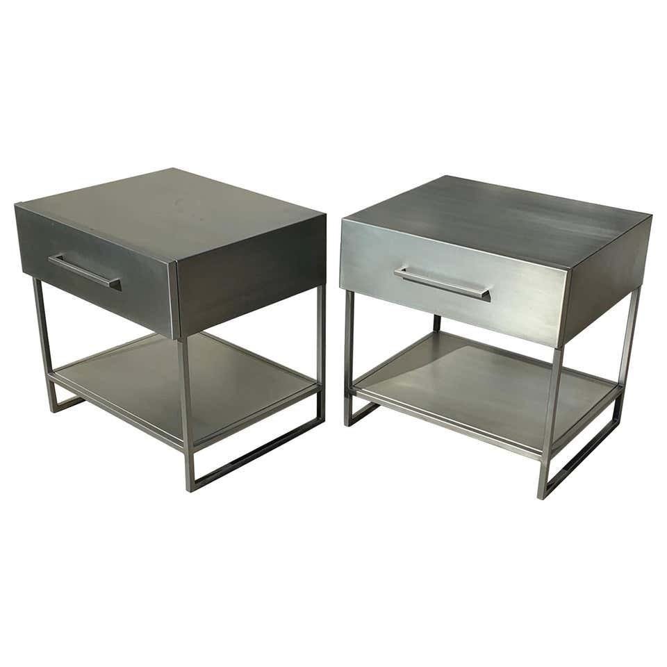 2 Industrial Nightstands/End Tables in Brushed Metal: Beautiful pair of industrial style nightstands executed in brushed steel. The pieces have beautiful lines, they each have one drawer and a shelf. The pieces show well and are ready for display. Measur