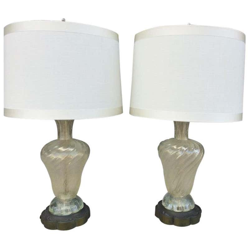 Pair of Murano Glass Lamps Made in Italy: Beautiful pair of murano glass lamps designed and manufactured in Italy, the lamps have beautiful bronze bases and are in very good condition, shades are not included. Measurements: 28" high to top of
