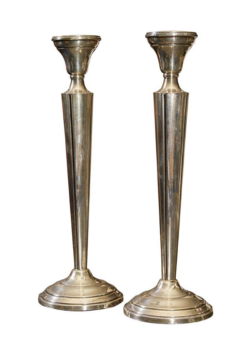 Pair of Neoclassic Style Sterling Silver Candlesticks: Each elongated tapering standard supporting urn-form candle cup, resting on a stepped circular base, each weighted and marked. The candlesticks are in good condition and need to be polished. Dimension