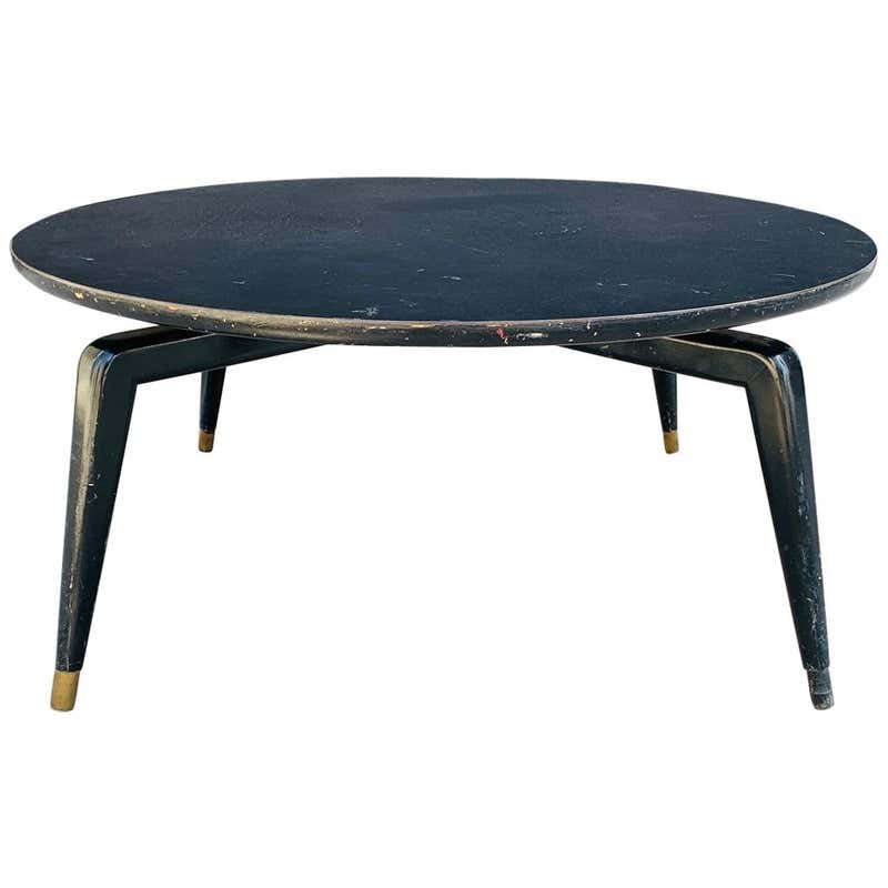 Vintage Coffee Table attb to Monteverdi-Young: Beautiful coffee table designed and manufactured in the 1950s and attb to Maurice Bailey for Monteverdi-Young.The table has a swivel top on a beatufully sculpted legs that have brass caps on the feet.