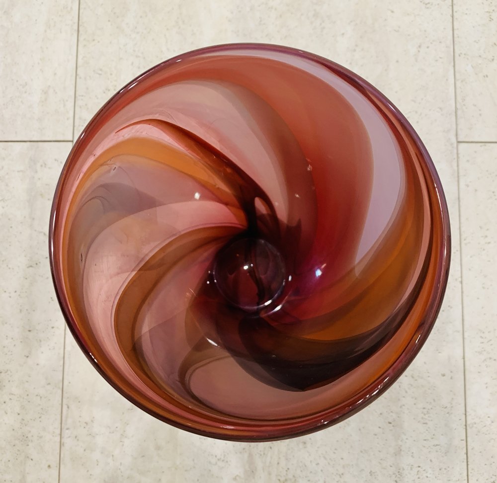 Beautiful Glass Vase by Max Studio: Stunning glass vase in different colors signed Max Studio.No nicks, or chips. Measurements: 9 inches high x 55.75 inches in diameter x 2.75 diameter at base. All items are sold as is. The auction hous