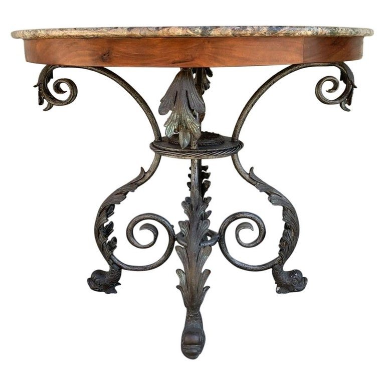 French Wrought Iron and Marble-Top Center Table: This French Dining Table features a 48" round marble top on a hand forged iron table base. The French design brings charming historic Old World elements into your dining room through its classic iron