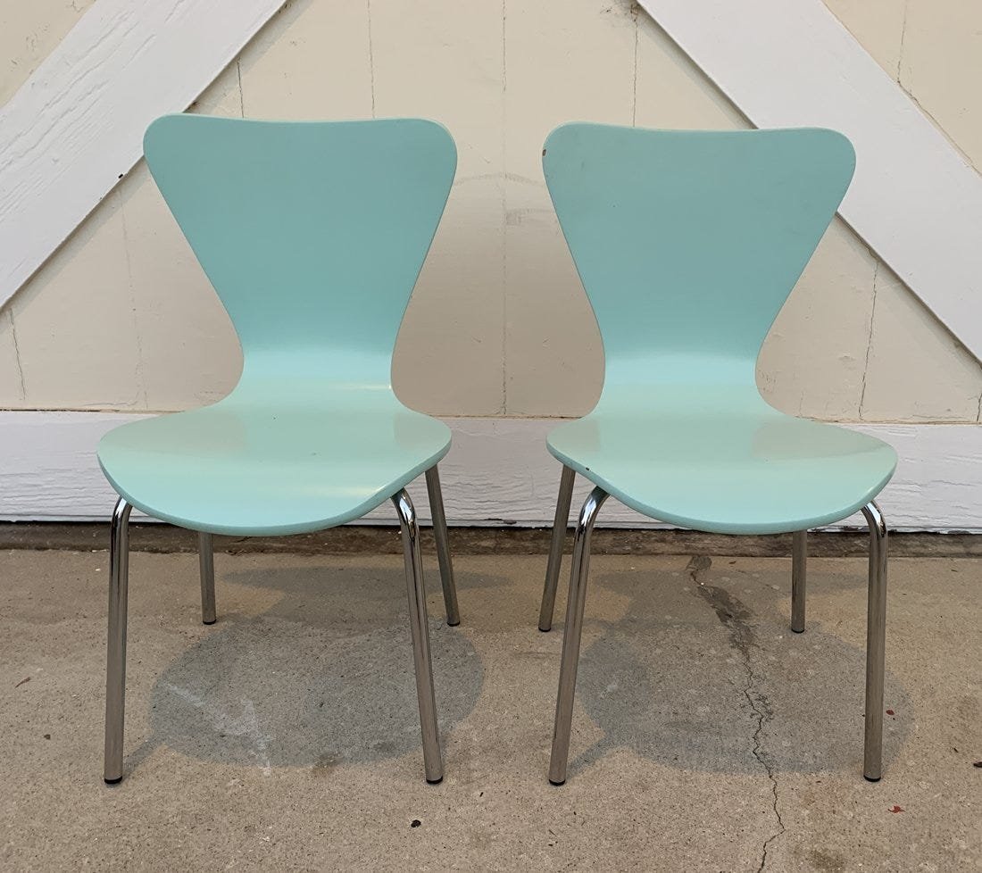 Pair of Mid Century Modern Style Kids Chairs: A lighthearted look and the perfect balance of style, comfort and affordability. They are molded plywood with a lacquered acqua finish. The base is steel. The chairs are stackable and perfect for home