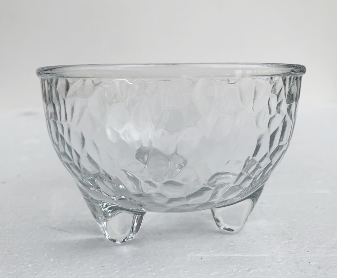 Textured Clear Small Footed Glass Bowl by Crisa: Textured glass footed bowl signed Crisa. Very good condition with little to no wear. Measurements: 4.25 inches diameter x 2.75 inches high. All items are sold as is. The auction house does not warrant