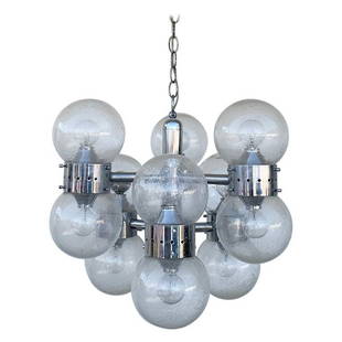 12 globe chandelier in Chrome & Glass after Lightolier: Beautiful midcentury modern chandelier with 12 globes/lights in the style of lightolier.The murano glass style globes are mounted on a chrome frame (one of the globes has been replaced).The piece is i