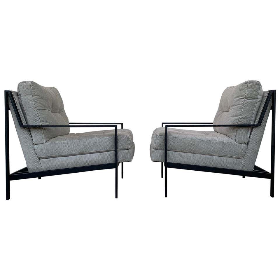 Pair of Mid-Century Modern Style Armchairs: Comfortable pair of armchairs with black metal frames and thick comfortable upholstered seat. The chairs are in in very good condition, the seat and backrest has a tufted finish and they are very styl