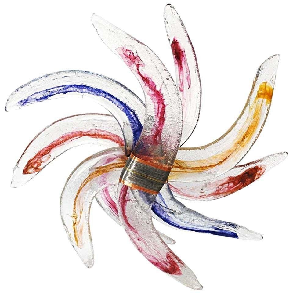 Monumental Glass Sculpture- Pinwheel Form - 40 Inches: Monumental glass floor sculpture in a pinwheel form with copper and steel wrapped center details. The glass has a wonderful texture and there are bright blue, red, yellow and orange colors infused on 