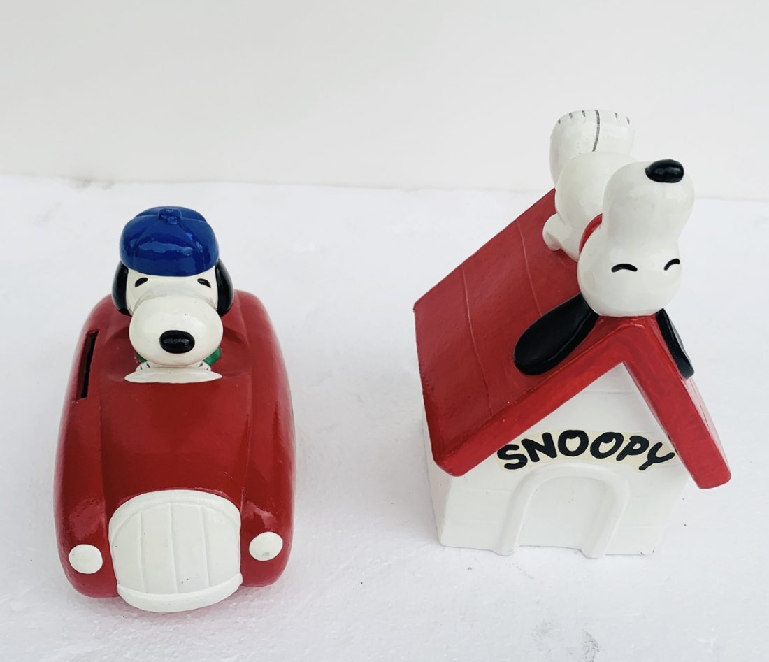 Pair of Vintage Snoopy Piggy Banks, Racer & Doghouse: Pair of vintage snoopy dog piggy banks, Racer & Doghouse.The dog house has a 1970 United Feature Syndicate Inc label, World Rights Reserved, Determined pRODUCTIONS iNC. Racer has a label that reads; S