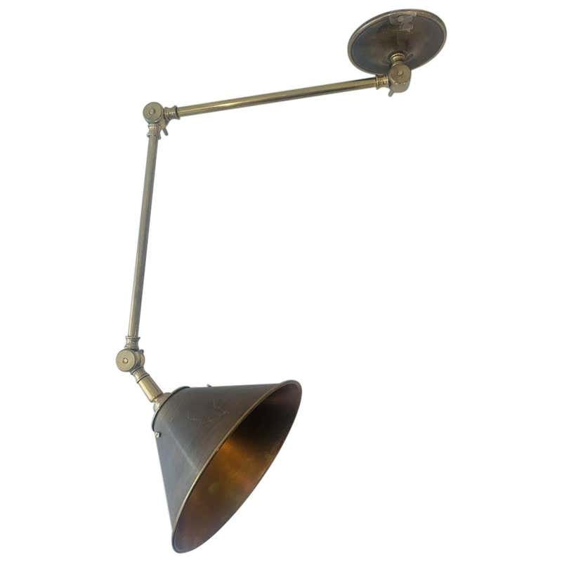 Library Sconce in Solid Brass by Paul Ferrante: Beautiful library/reading light designed and manufactured in Los Angeles by Paul Ferrante. The piece is made in solid brass and it is in very good condition. The light takes one 60W light bulb. Measur