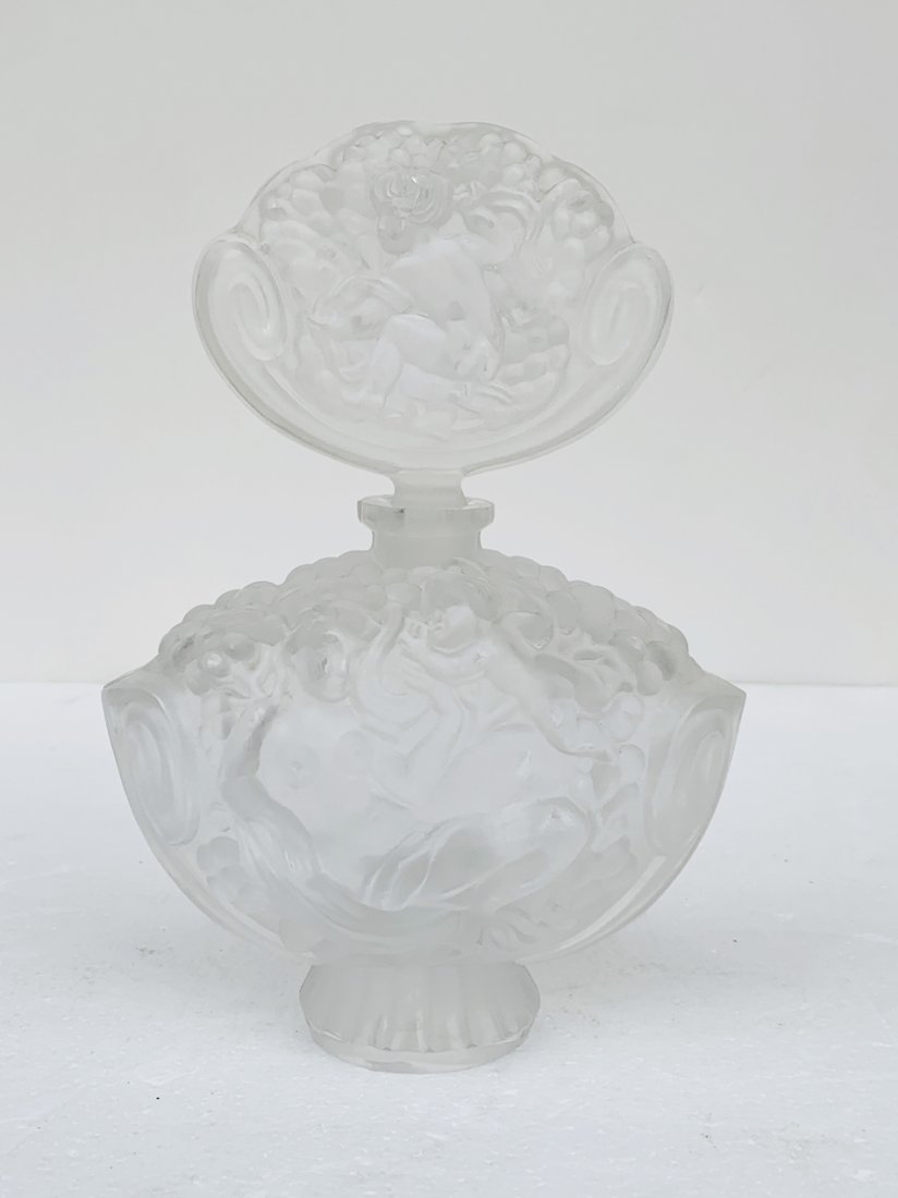 Large Perfume Crystal Bottle & Stopper: Beatuful crystal perfume bottle marked #493 The piece has beautiful design, with an etched cherub on the stopper and nude figures on the bottle. All items are sold as is. The auction house does not wa