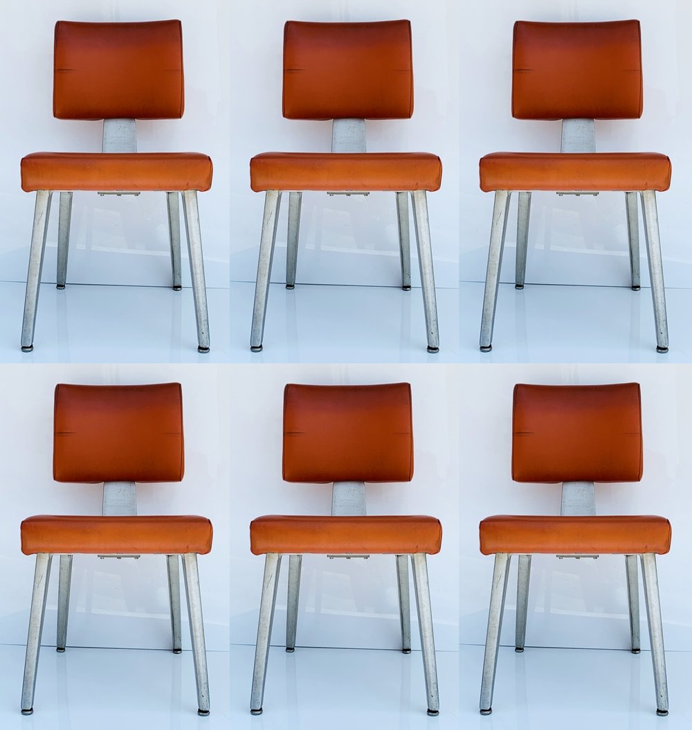 Set of 6 Dining Chairs by GoodForm: Mid 20th century modern General Fireproofing GoodForm aluminum industrial task chairs in original red naugahyde upholstery.The chairs are in good vintage condition, there are nicks to legs and upholst