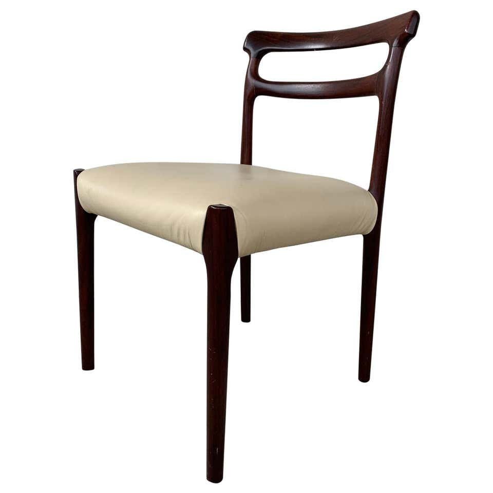 Danish Style Accent Chair: Beautiful side chair in the Danish style upholstered in cream vinyl and with a dark mahogany wooden frame. The chair has beautiful lines and is in good vintage condition. Measurements: 30.50 inches hi