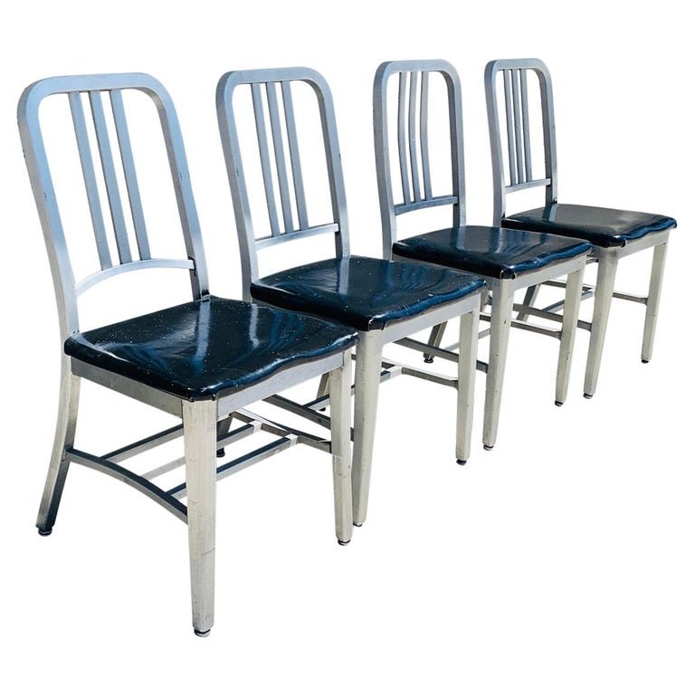 Set of 4 Aluminum Chairs by Goodform: Set of 4 aluminum chairs from the 1950s or earlier, designed and manufactured in the USA by Goodform.The chairs are very lightweight, the seats are upholstered in black vinyl which is original to the