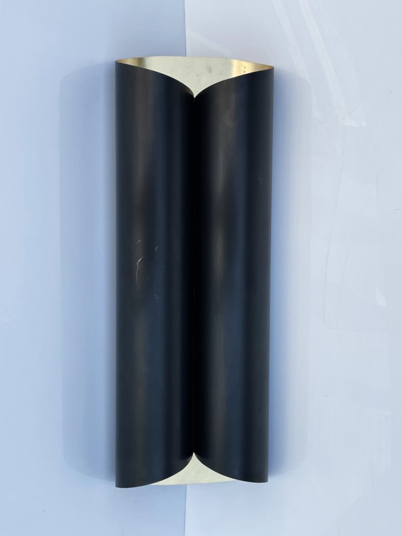 Gunmetal & Brass Scrolled Wall Sconce: Beautiful and modern scroll shape wall sconce, with gunmetal and gold leaf finish. The piece is well made it goes well with many design aestethics. Measurements: 23 inches high x 8 inches wide x 4.75 