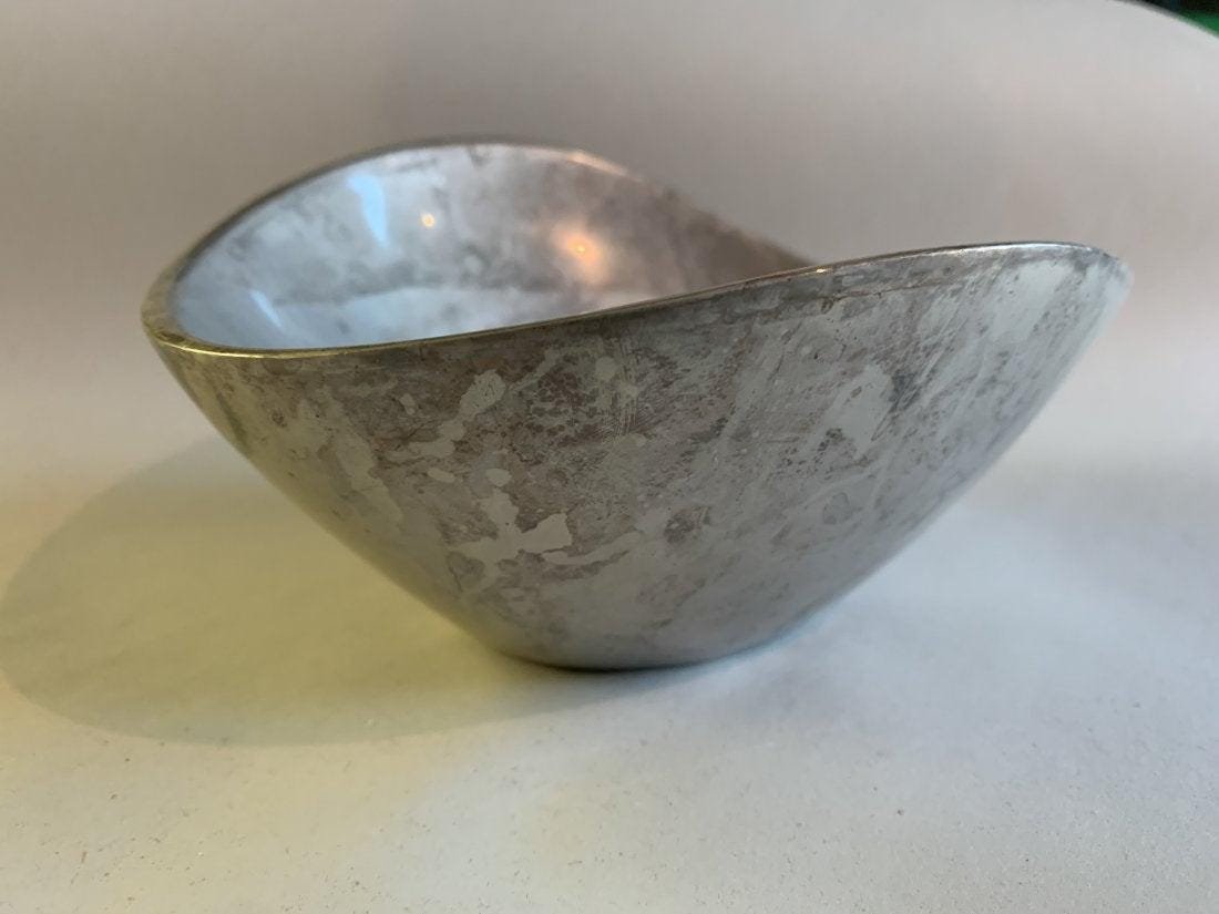 Nambe Butterfly Bowl Number 567: Among Nambe's earliest designs, the Butterfly Bowl celebrates both form and function. Aesthetically pleasing to the eye, the elongated sides gracefully reach upward like wings to create its simple, el