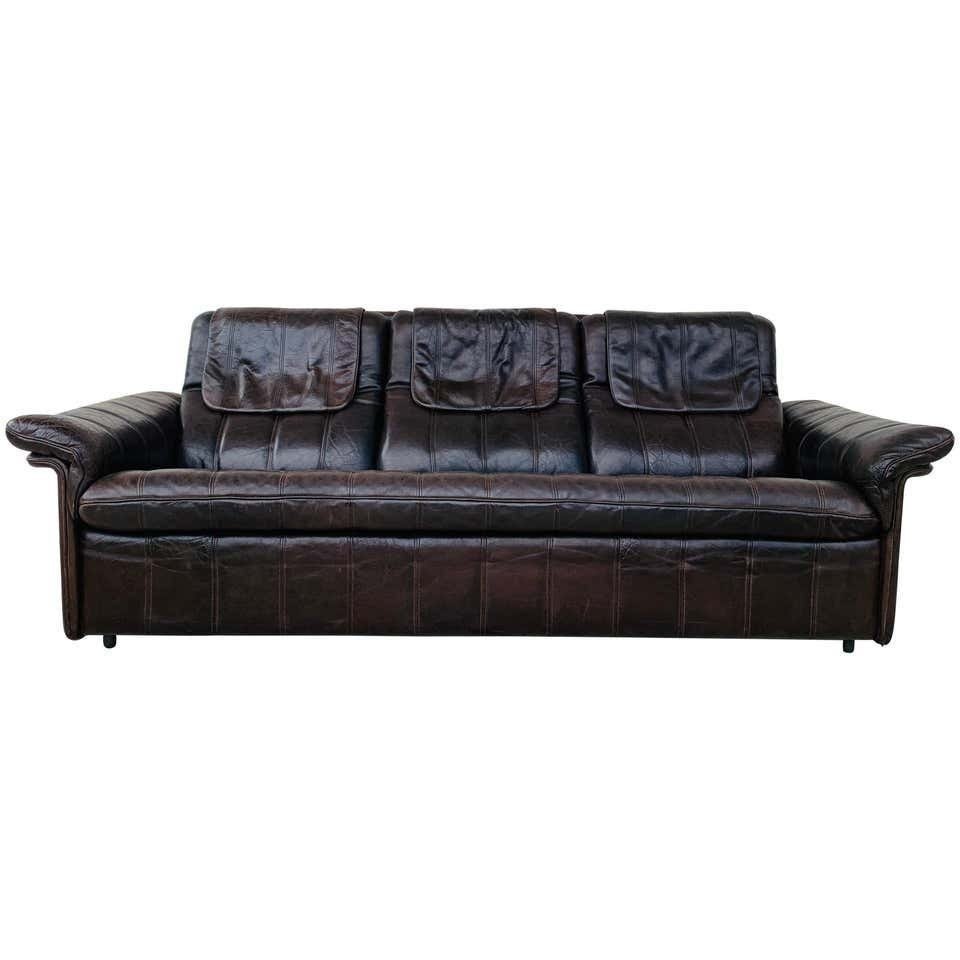 3-Seat Leather Sofa by De Sede, Switzerland: Vintage 3-seat sofa upholstered in brown leather designed and manufactured in Switzerland by DeSede.The piece is all original and is in good vintage condition.Measurements:79 inches wide x 33 inches d