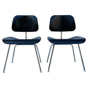 2 Molded Plywood Side Chairs by Charles & Ray Eames: The Eames Molded Plywood dining chair metal base, known as DCM, is a classic example of the Eamesesâ€™ philosophy of using honest materials. The chair, designed in 1946, uses two pieces of