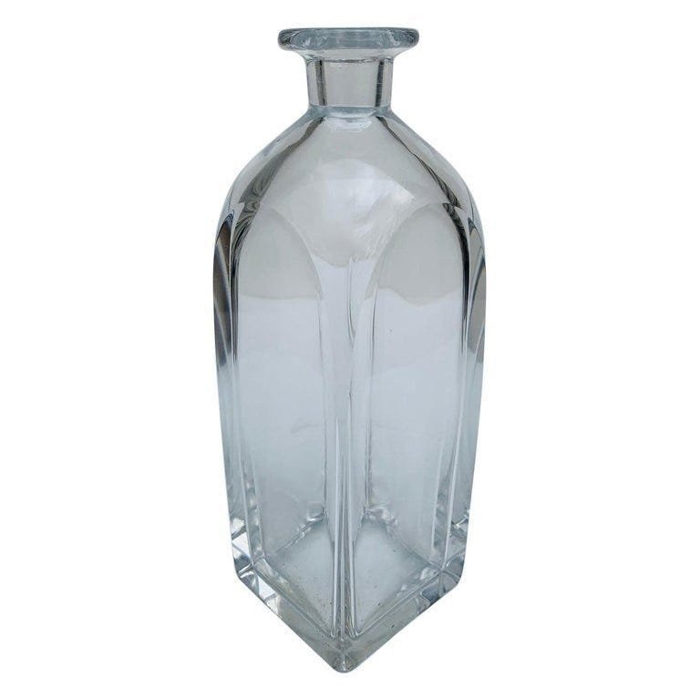 Vintage Decanter by Orrefors, ca 1960s: Vintage crystal decanter and stopper made in the 1960s by Orrefors.The bottle labeled and in very good condition.Measurements:9.25 inches high x 3 inches squareAll items are sold as is. The auction ho