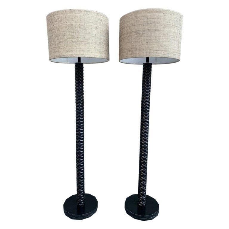 Pair of MONTCLAIR FLOOR LAMPS by PALECEK: Pair of Palecek Montclair Floor Lamps Measurements: 20 wide X 67-1/2 high (inches) rich dark finish on plantation grown hardwood with hand-carved detail. Natural raffia shade and gold metal finialrequ