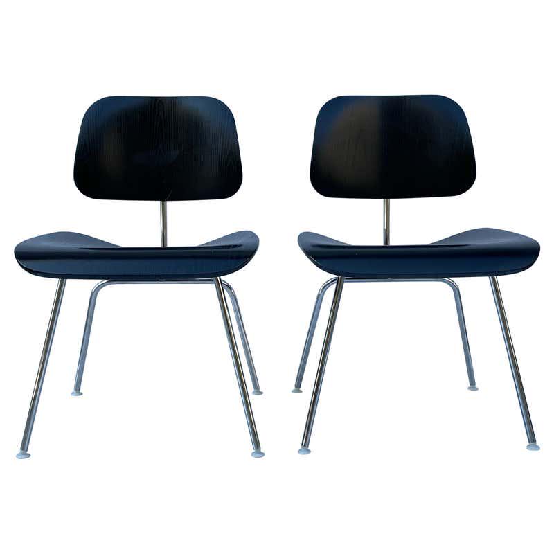 2 Molded Plywood Side Chairs by Charles & Ray Eames: The Eames Molded Plywood dining chair metal base, known as DCM, is a classic example of the Eamesesâ€™ philosophy of using honest materials. The chair, designed in 1946, uses two pieces of molded