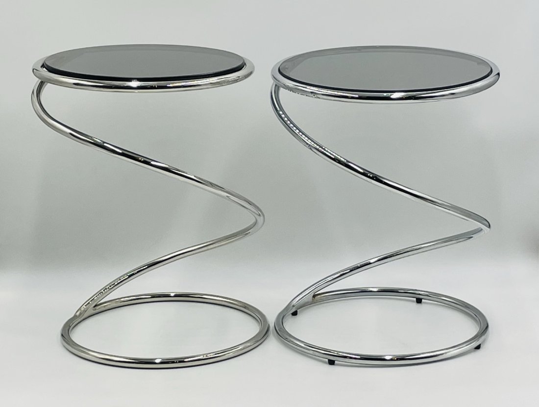 Stunning pair of chrome & glass side tables by Leon Rosen for Pace Collection: Sculptural pair of 1970s Pace Collection chrome spring tables. This pair of polished chrome and glass tables are called the "Spring Table" and were designed by Leon Rosen for the Pace Collection. The