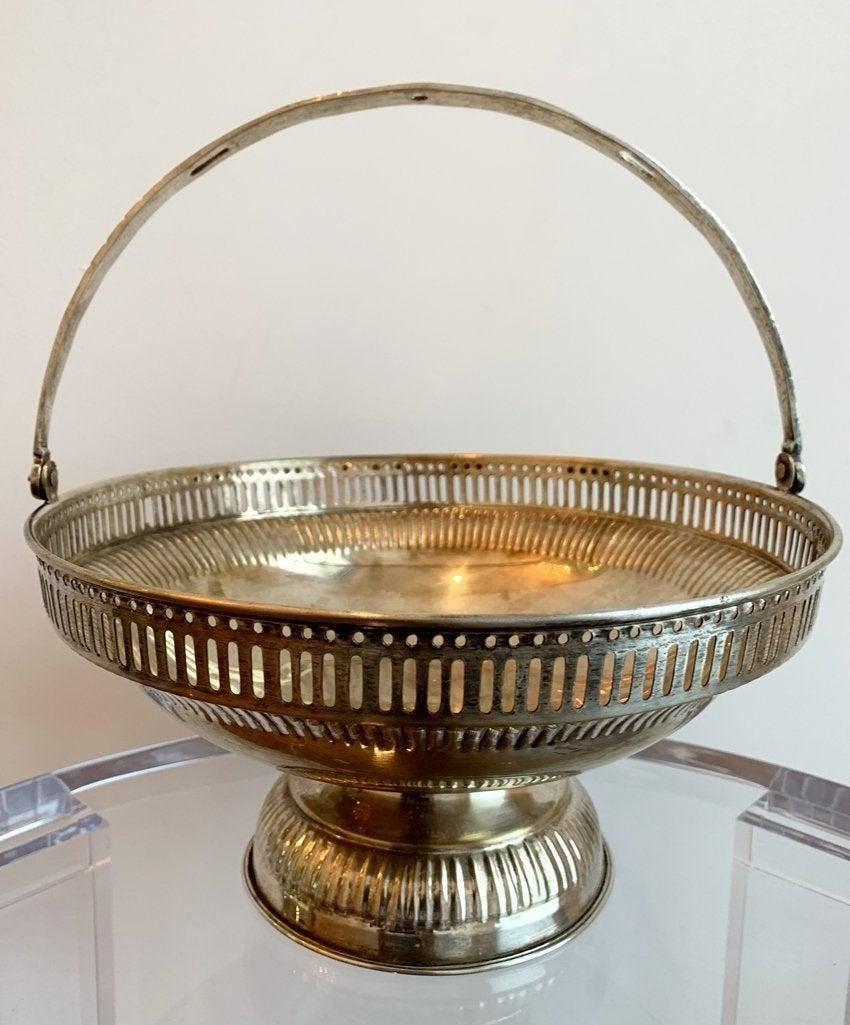 Antique Sterling Silver Pierced Bread Basket: The basket is tarnished and needs polishing. Measurements: 5.25 inches high-11 inches high including the handle x 10.50 inches in diameter. All items are sold as is. The auction house does not warrant