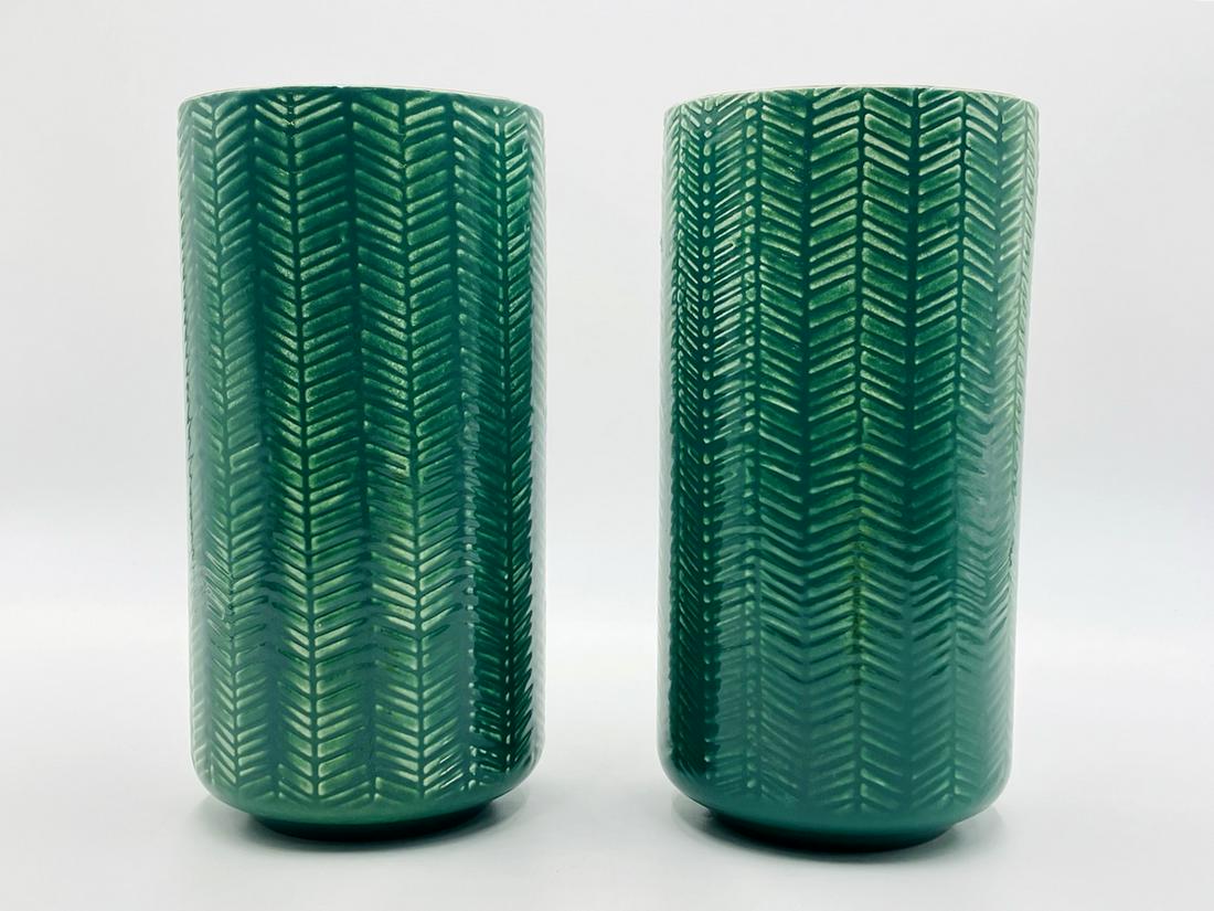 Pair of Ceramic Vases made in Portugal: Pair of green ceramic vases made in Portugal, the vases have a green glaze with a chevron pattern. Both marked. Measurements: 10.50 inches high x 5 3/8 inches in diameter. All items are sold as is. Th