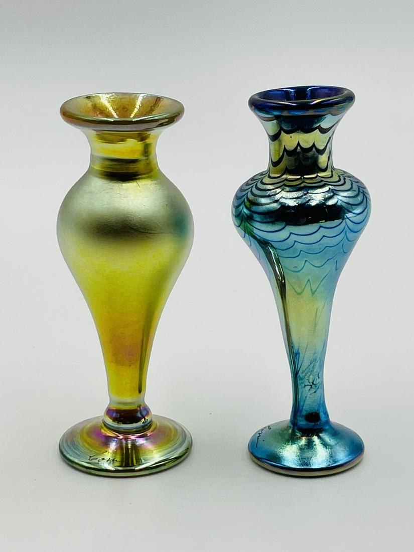 Pair of Iridescent Bud Vases by Correia Art Glass, Signed: Pair of iridescent art glass vases by Correia Art Glass of Santa Monica California, both signed by the artist. Measurements: cobalt with pulled feather design; 5 inches high x 2 inches in diameter x 1