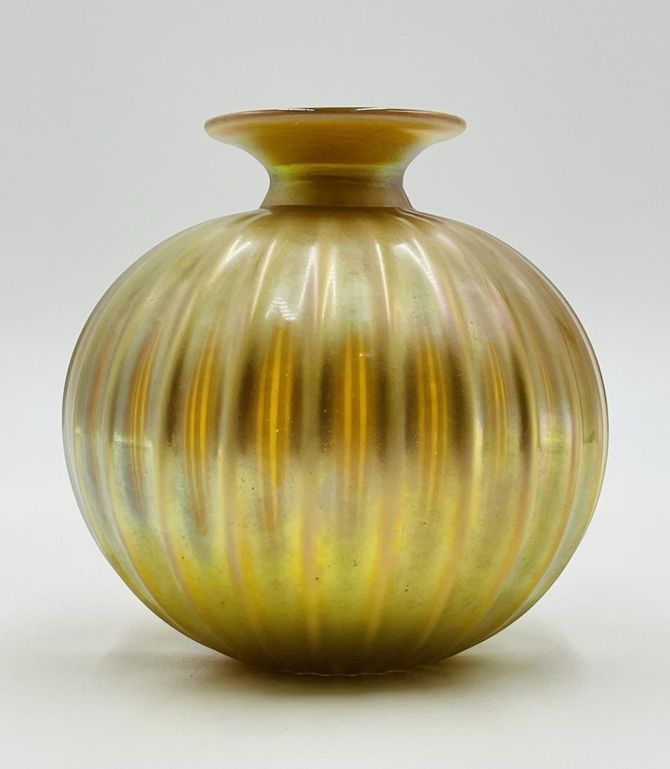 Gold Iridescent Art Galss Vase by Steven Correia, Signed: Gold toned studio art glass vase, handblown and rolled with a golden iridescent coloring that reflects the light in a number of shades. The piece is signed. Measurements: 7.50 inches high x 7 inches i